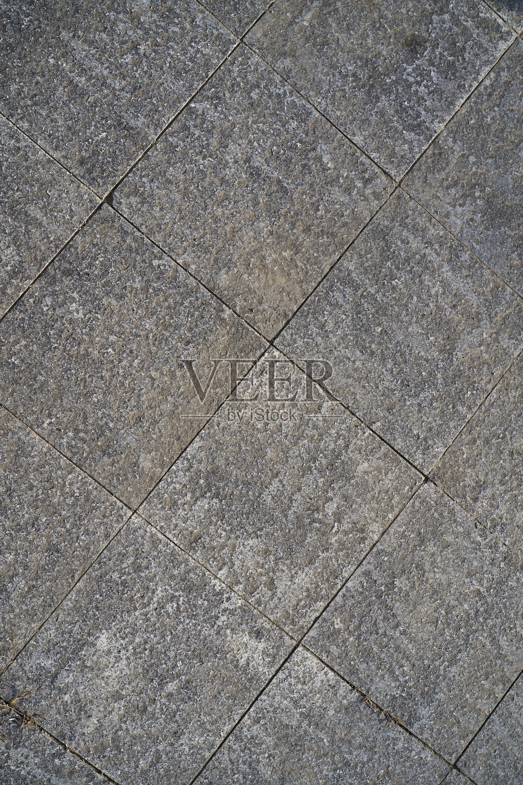 地面上形成几何图案的纹理铺砖照片摄影图片