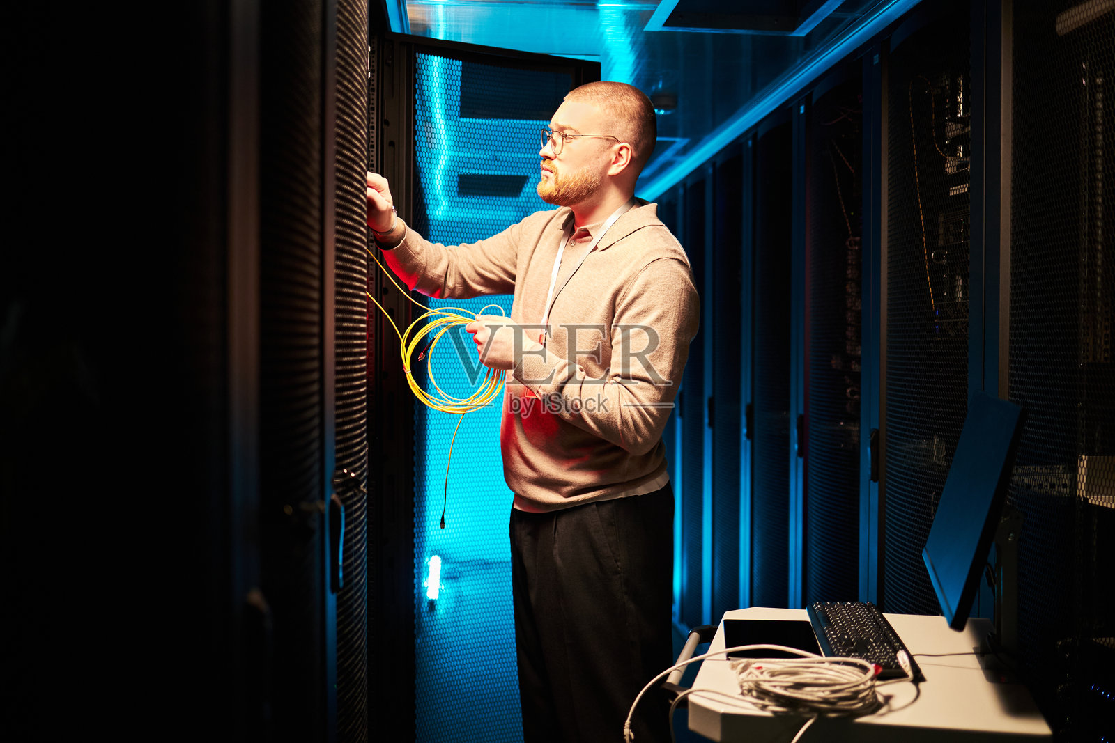 技术人员在服务器机房连接网络电缆照片摄影图片