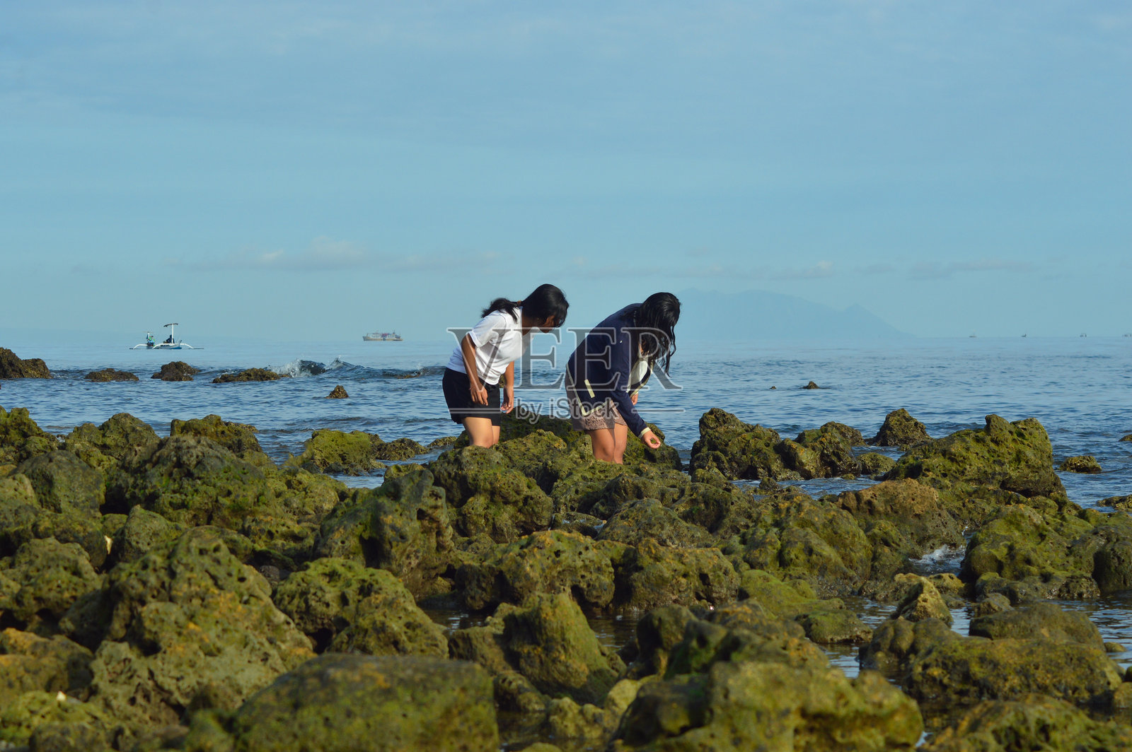 青少年女孩弯下身子观察有趣的事物照片摄影图片
