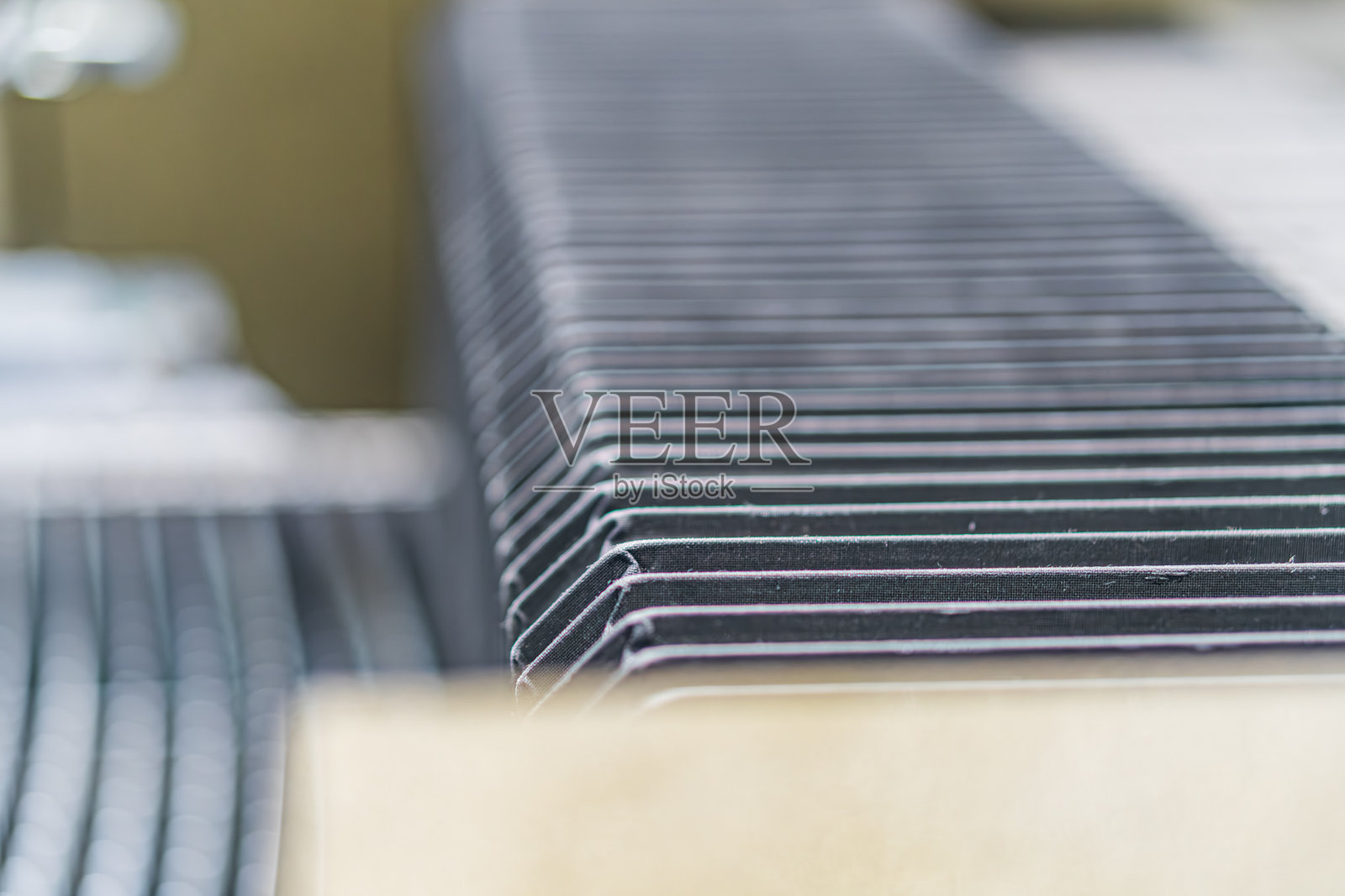 工业环境中,电子元件在传送带上被自动化机械处理,机械部件包括滚筒、传送带和检测系统,重点在于有序的生产。照片摄影图片