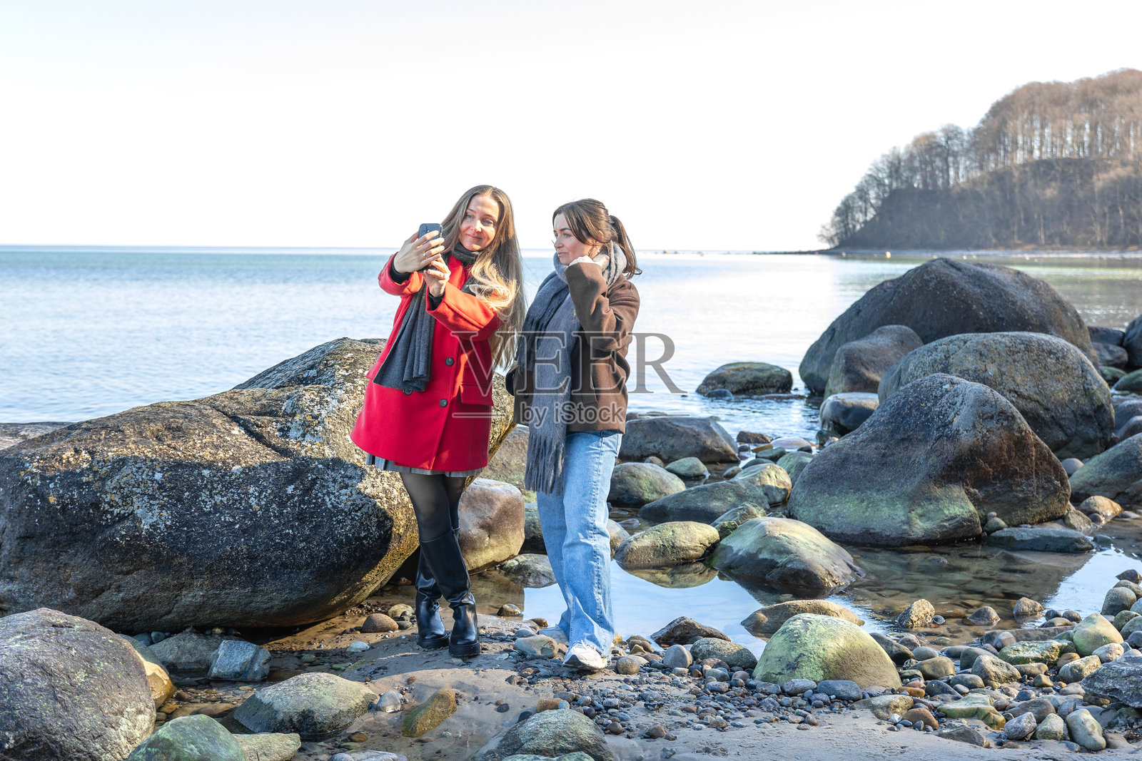 两位女性在海岸边散步。两个朋友一起享受和度过时光。照片摄影图片