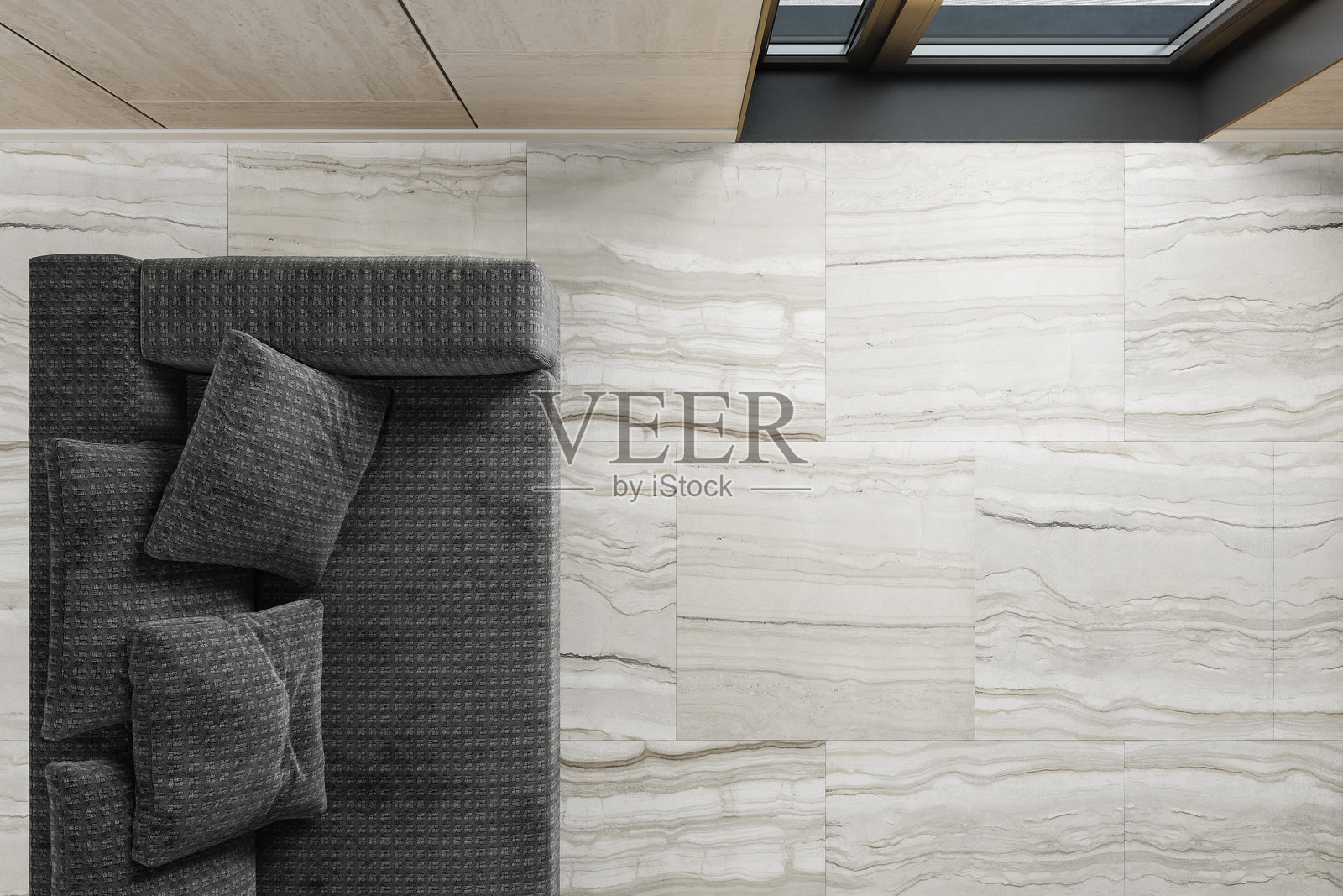 现代居住空间的俯视图,配有灰色沙发和哑光石材瓷砖地板照片摄影图片