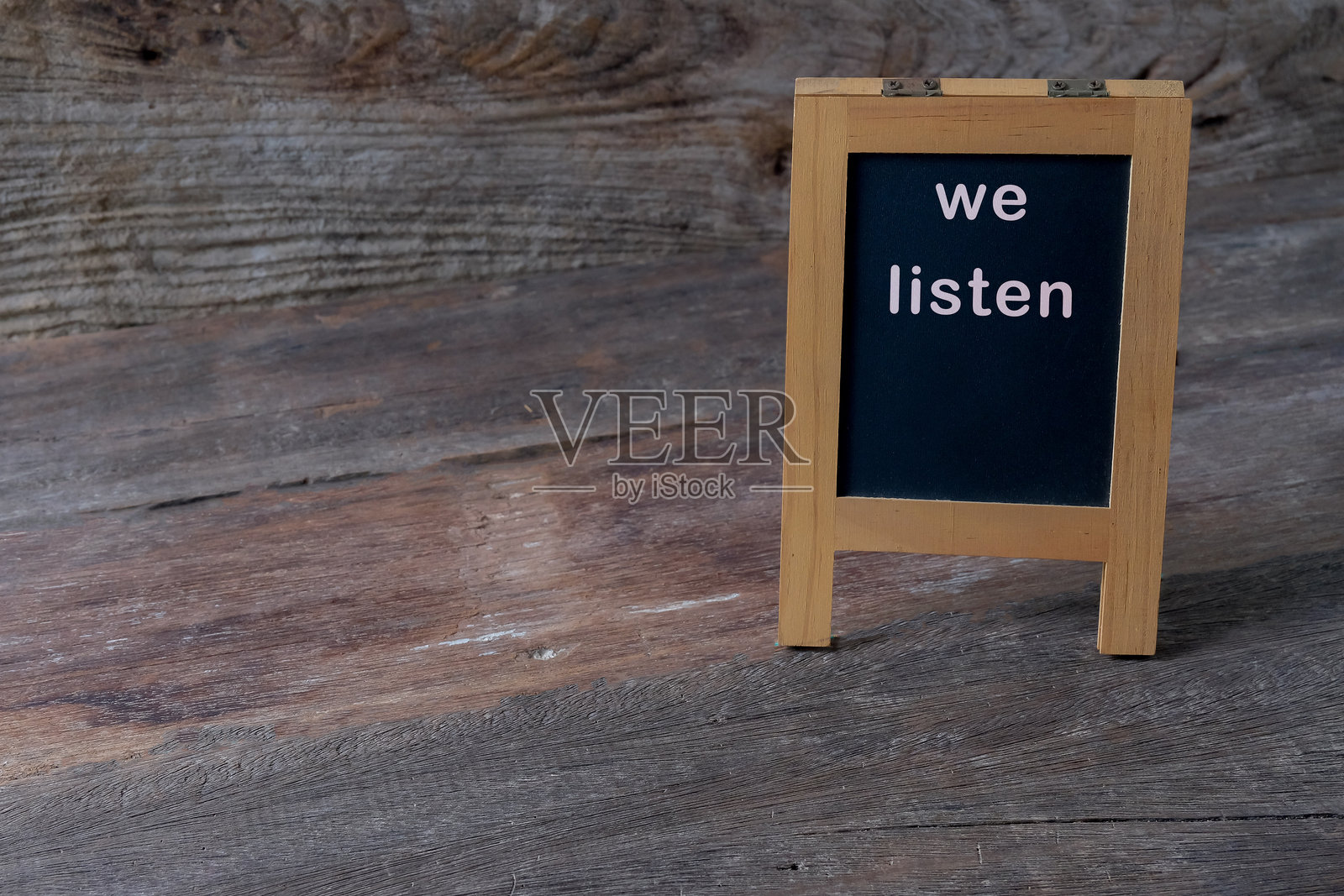 我们倾听目录在木质背景上的黑板上。照片摄影图片