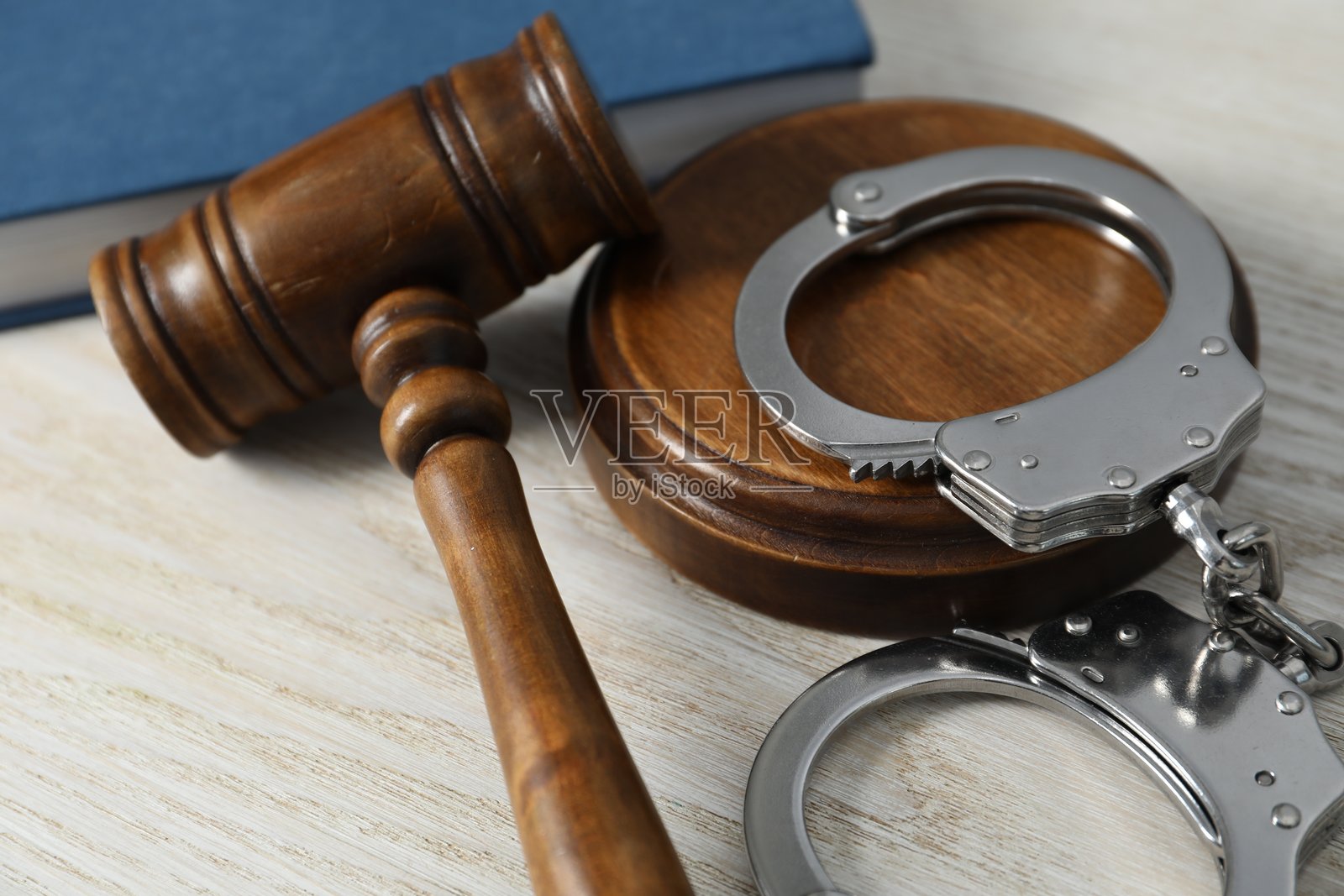 白色木桌上的手铐和法官的槌子,特写镜头照片摄影图片