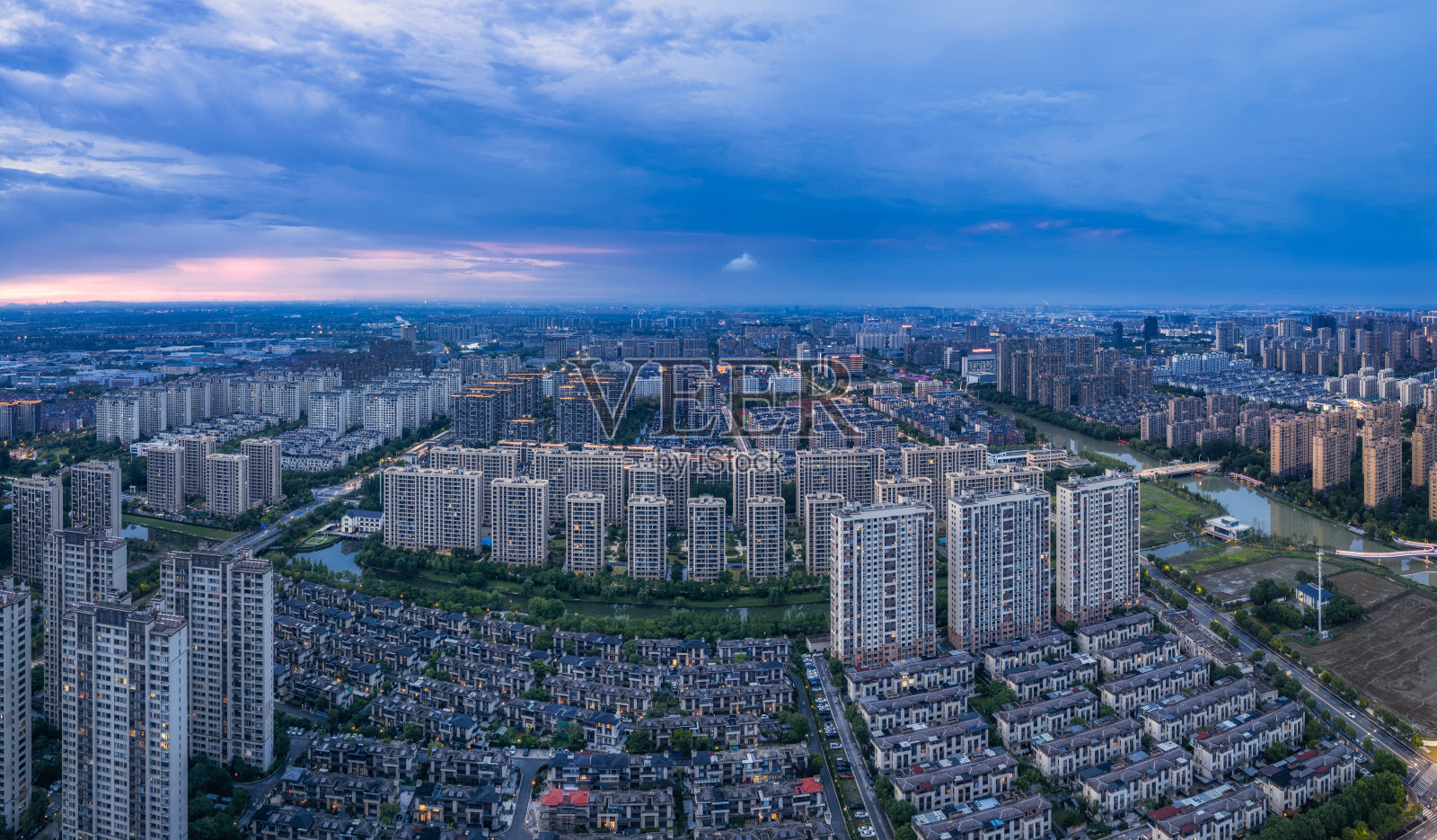 中国一片广阔的住宅区全景,高层公寓在戏剧性的黄昏天空下。照片摄影图片