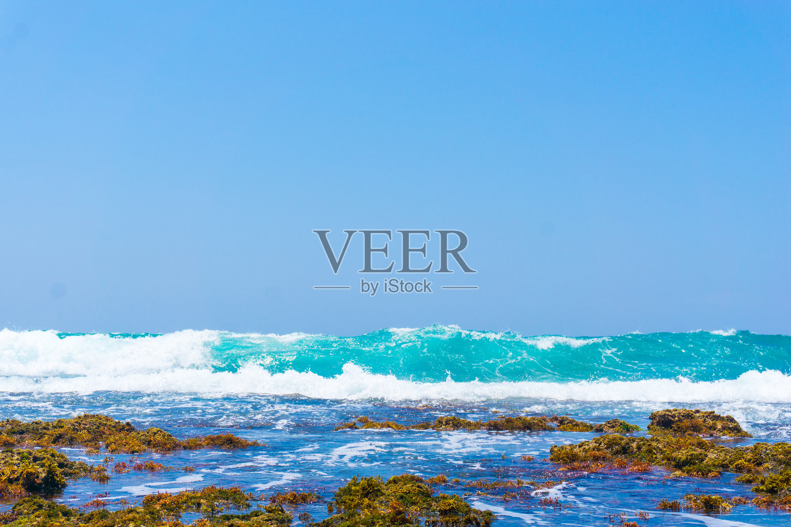 大块的石头和巨石进入大海,把沙滩围起来照片摄影图片