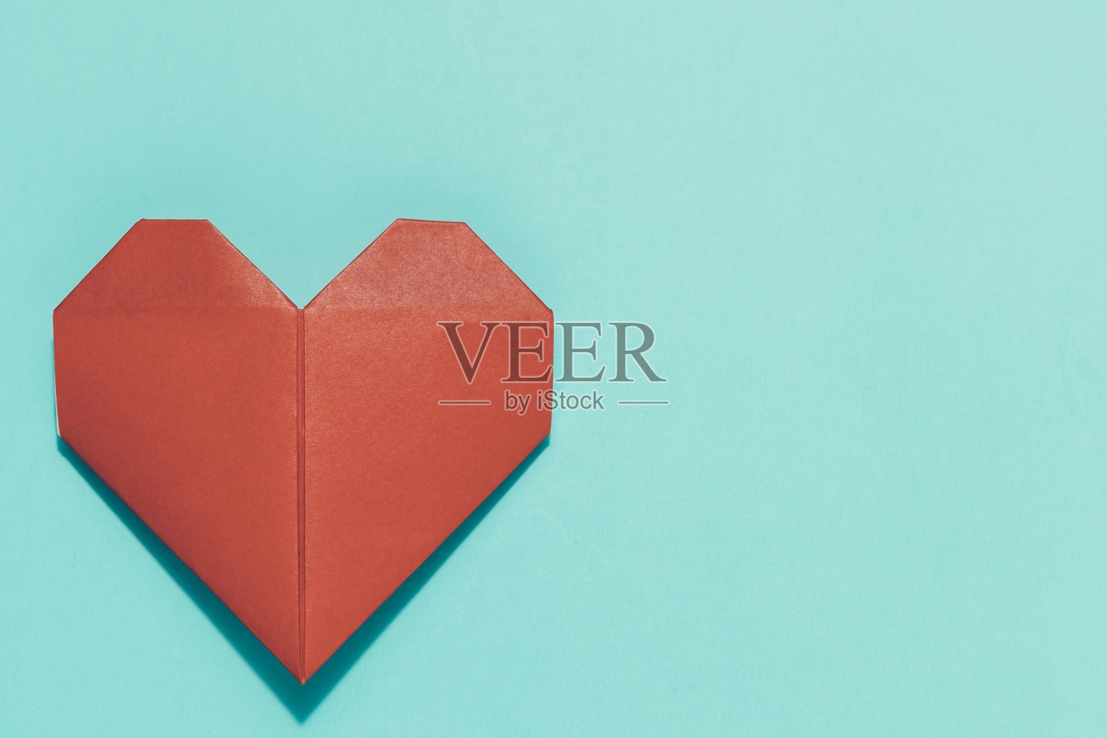 蓝色背景上的红色折纸心,爱情与手工艺概念照片摄影图片