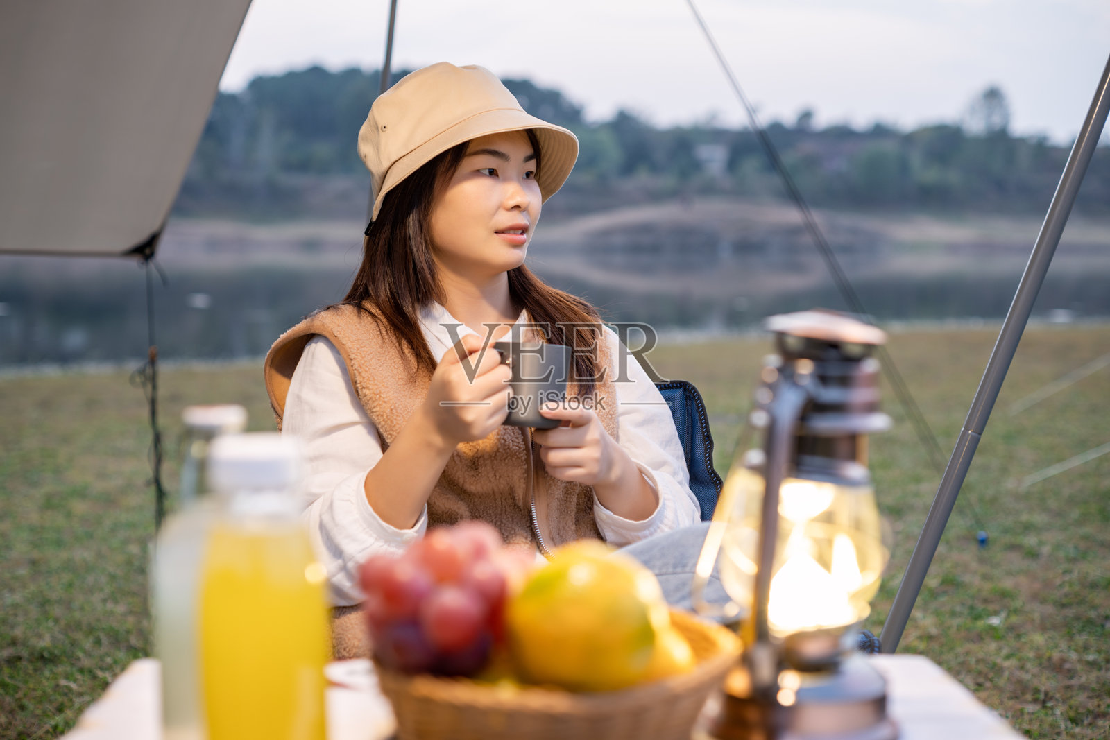 女人在露营时手握杯子享受宁静时刻照片摄影图片