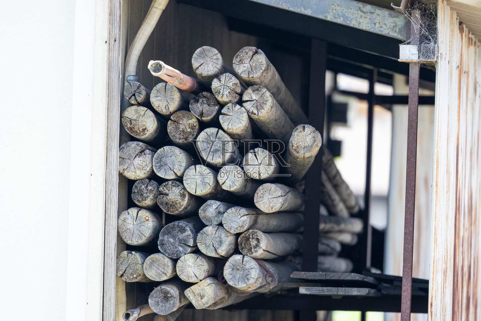 仓库内堆放的木材,屋顶为铁皮结构照片摄影图片