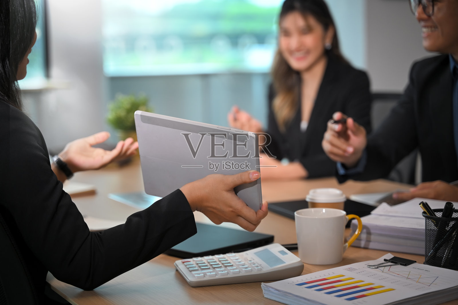 同事们在现代办公室合作,讨论财务数据和营销策略照片摄影图片