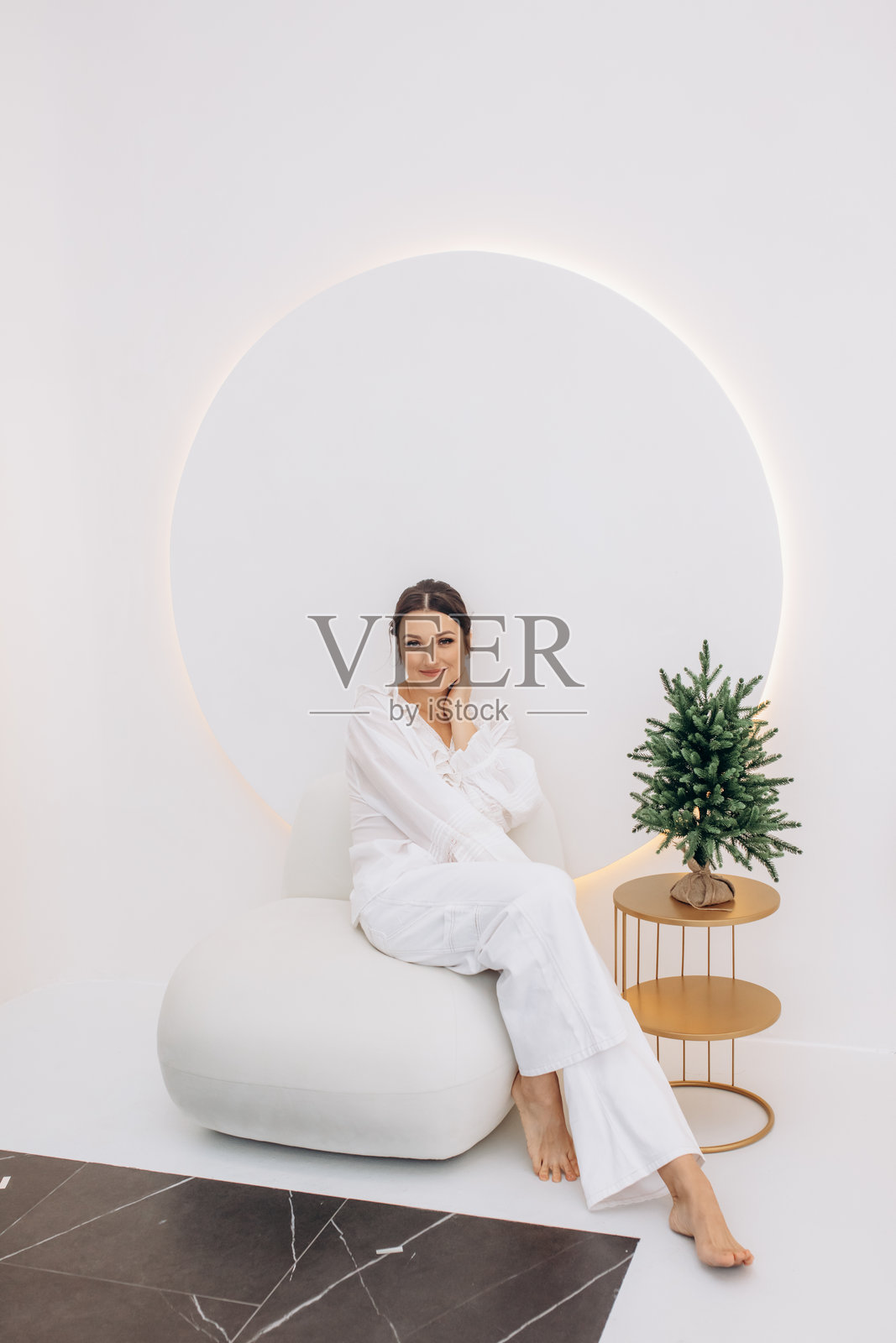 美丽时尚的棕发模特穿着白色牛仔裤和衬衫,庆祝圣诞节照片摄影图片