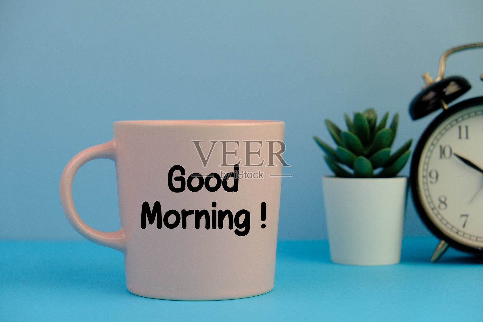 蓝色工作环境背景下的咖啡杯上的早安信息照片摄影图片