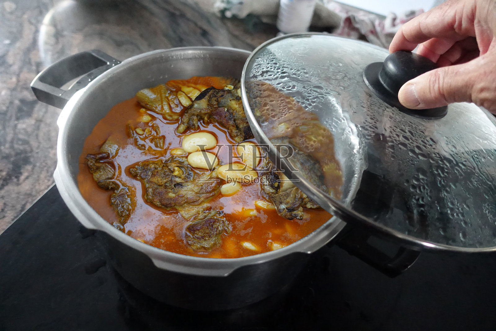 烹饪中的香辣羊肉炖豆子照片摄影图片