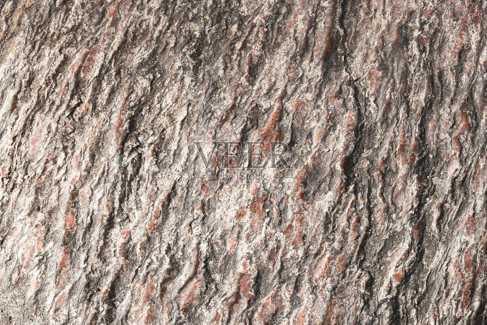 天然石材表面特写,粗糙的墙壁纹理背景,实心矿物材料图案,详细的岩石表面结构。照片摄影图片