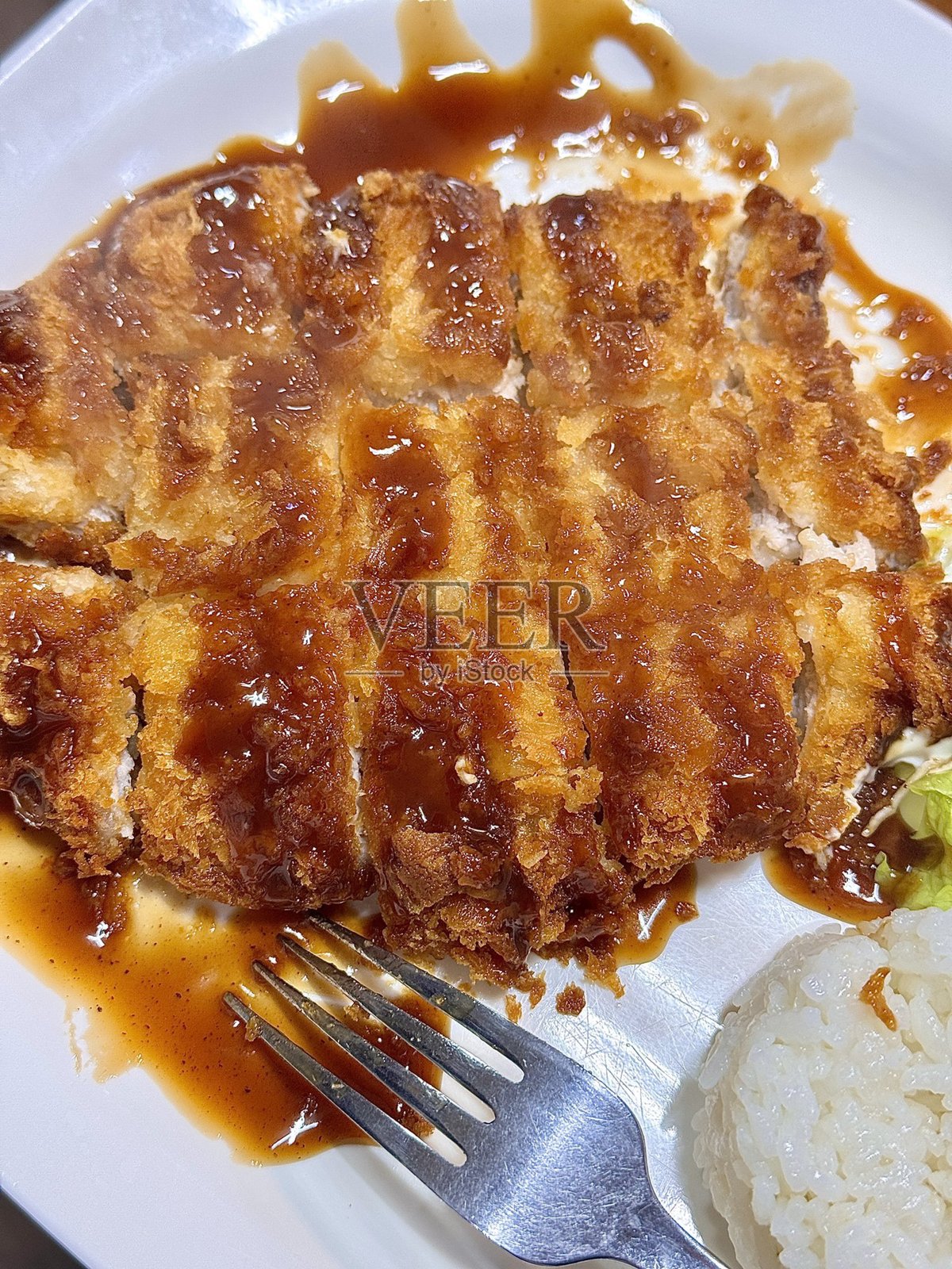 酥脆的日式炸猪排,配有卷心菜丝,淋上鲜美的酱汁。香脆口感与多汁肉质的完美平衡。照片摄影图片