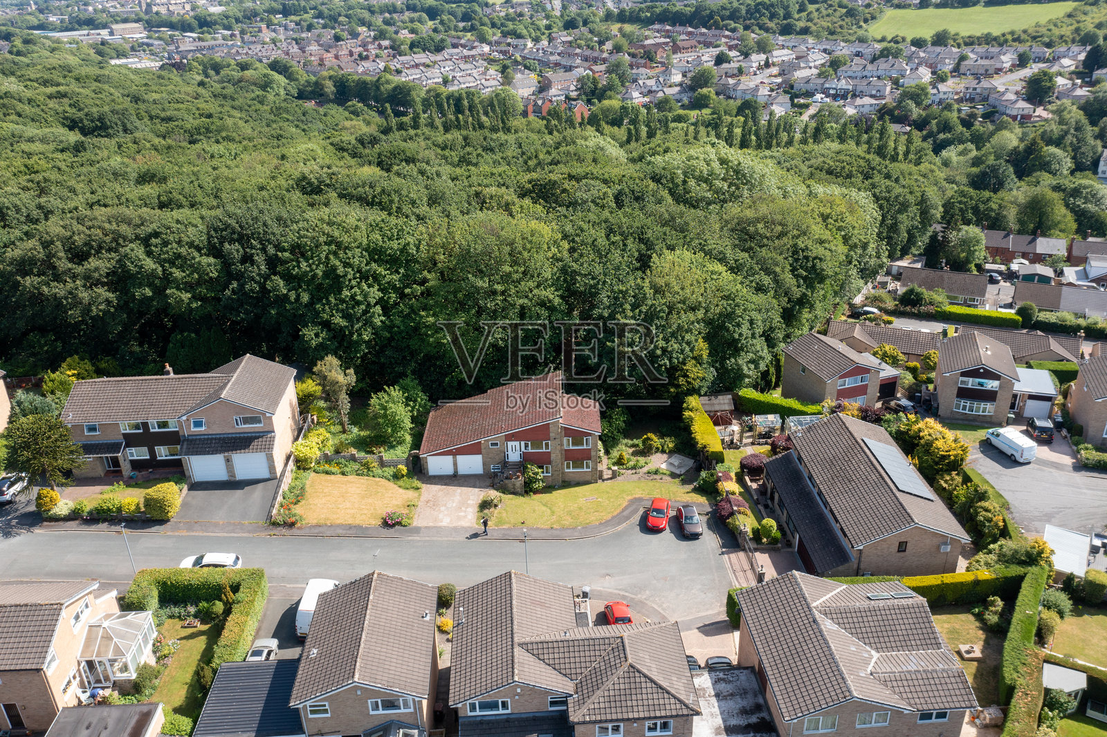 英国西约克郡布拉德福德市的航拍无人机照片,展示了典型的英国住宅区,在阳光明媚的夏日里可以看到街道、郊区房屋和花园照片摄影图片