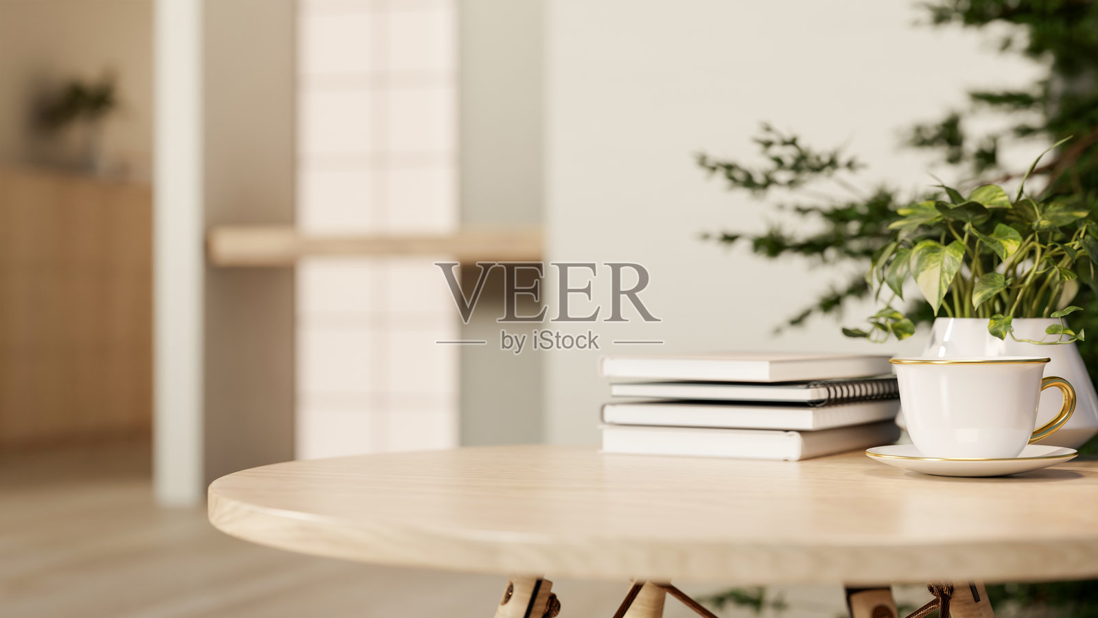 现代客厅或咖啡馆的木桌上,放着一个陶瓷杯的咖啡或茶,旁边有书和盆栽。照片摄影图片