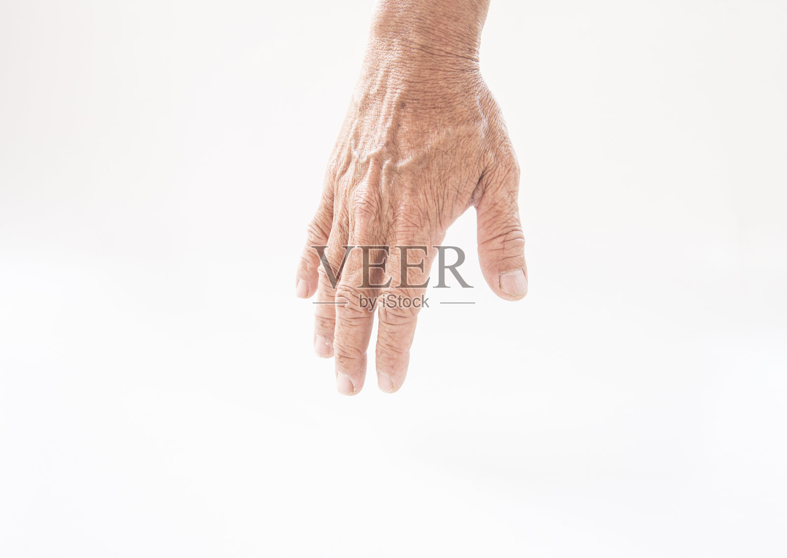 特写:一只手在白色背景上竖起大拇指照片摄影图片