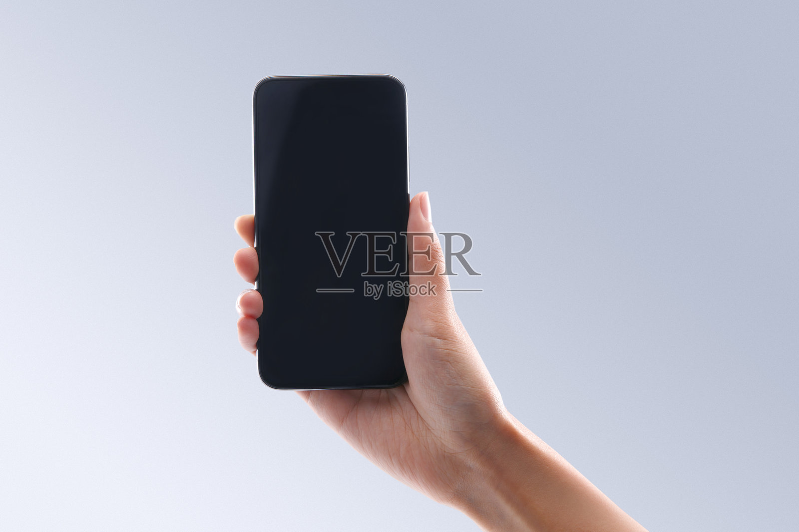 手持黑色智能手机,屏幕为白色空白占位符照片摄影图片