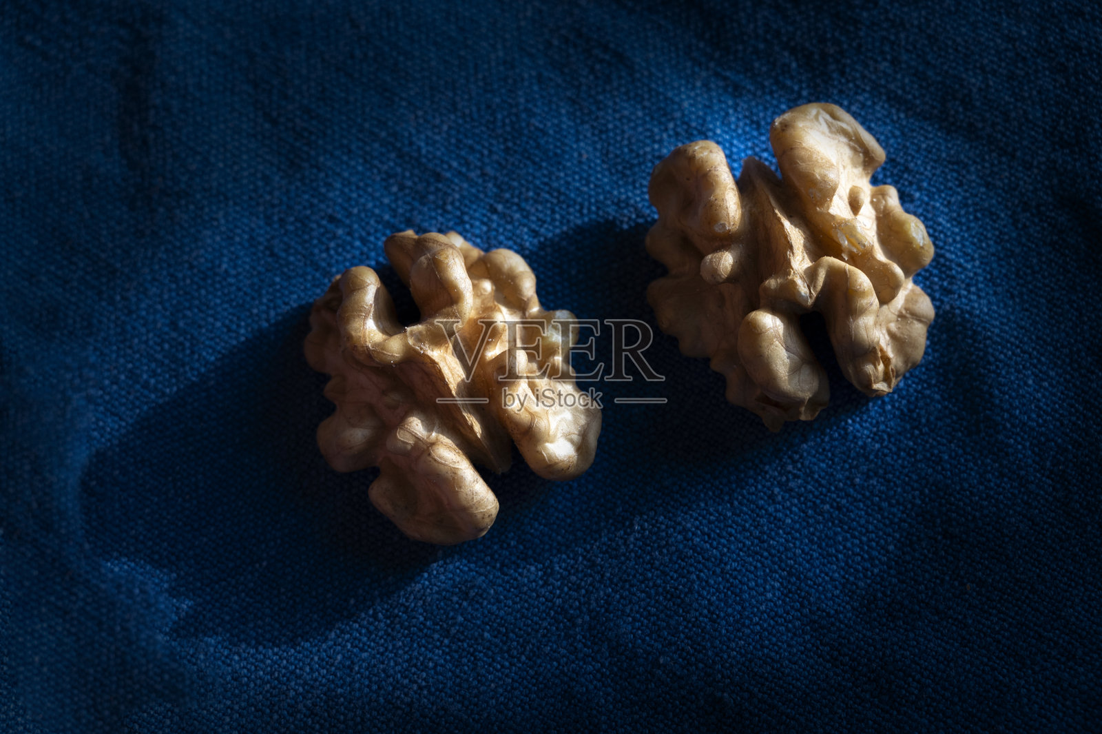 白色盘子里的完整核桃和去壳核桃特写照片摄影图片