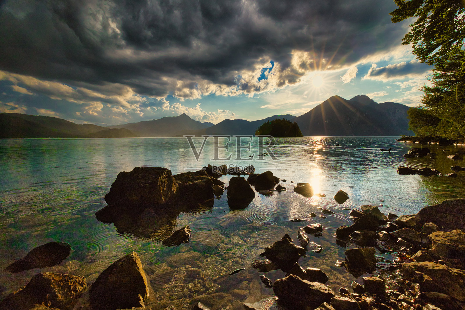 夕阳映照下的戏剧性山景,深色云彩倒映在瓦尔兴湖中照片摄影图片