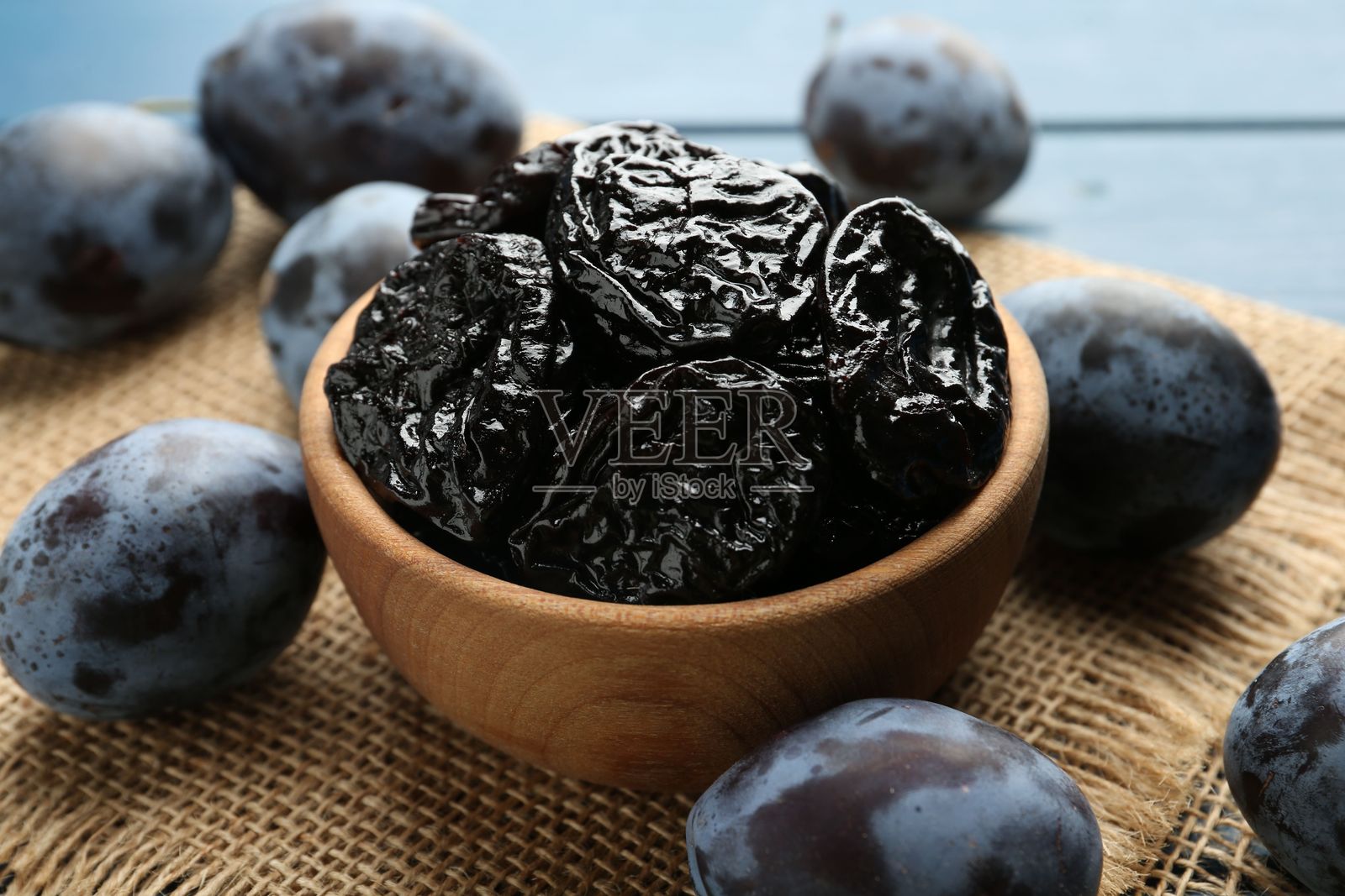 桌上的干梅子和新鲜李子,特写照片摄影图片