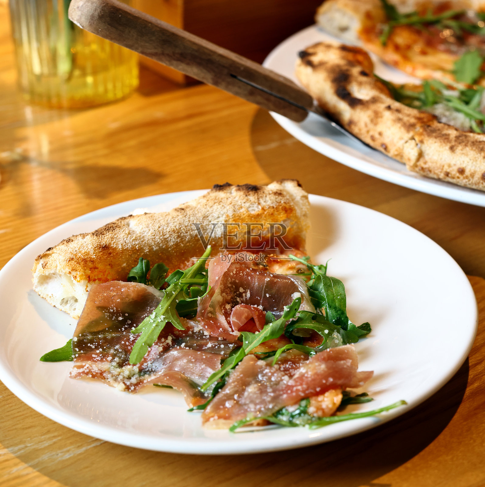 火腿、新鲜芝麻菜和帕玛森芝士的披萨照片摄影图片