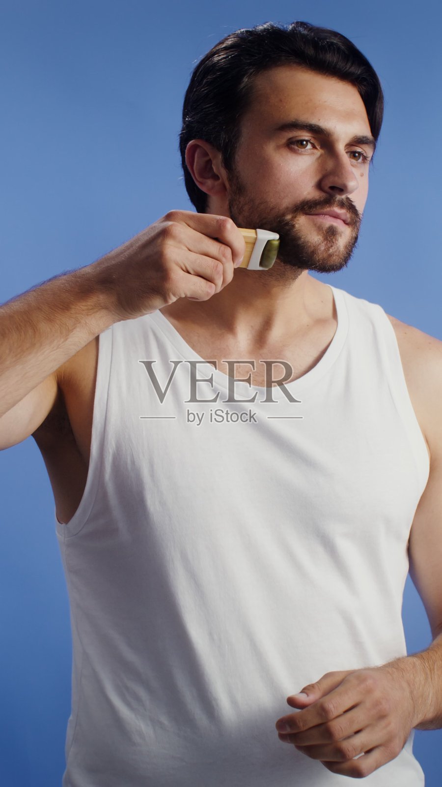 年轻男子进行面部提拉按摩——护理照片摄影图片