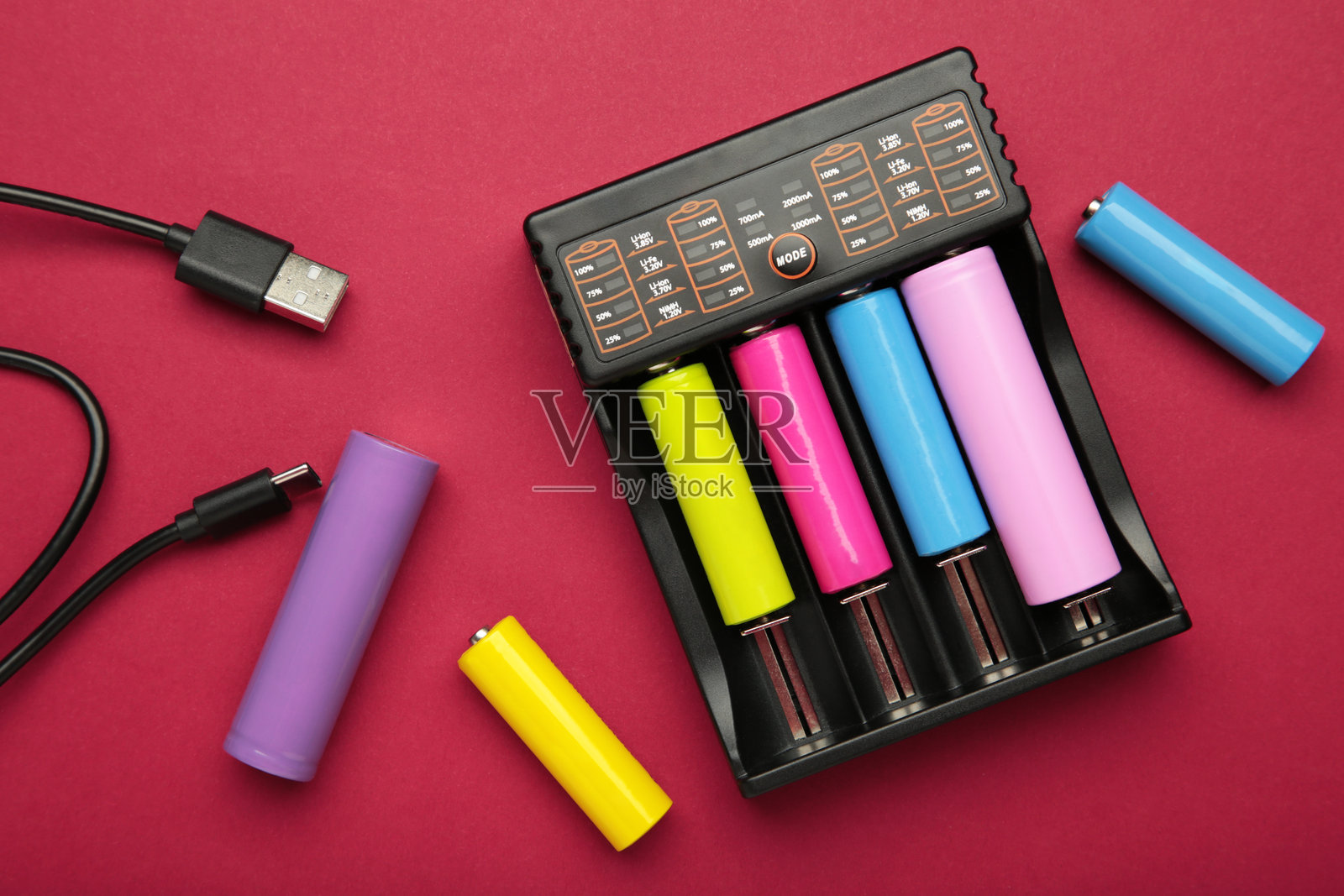 充电器中的可充电电池。充电器里有四节电池。NI-MH 和 LI-MH 电池。照片摄影图片