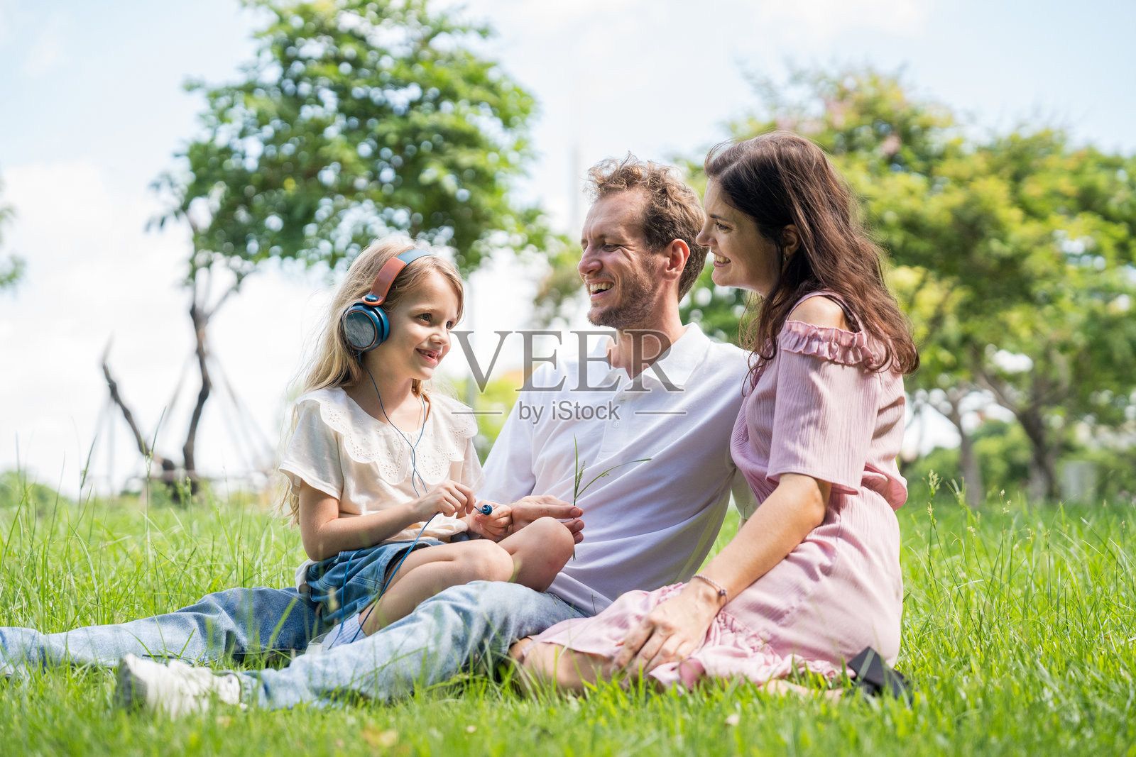 快乐的一家,父母和孩子们在户外野餐。享受夏日的美好时光,爸爸妈妈和儿子女儿一起玩耍,在清晨的日出时分放松身心。照片摄影图片