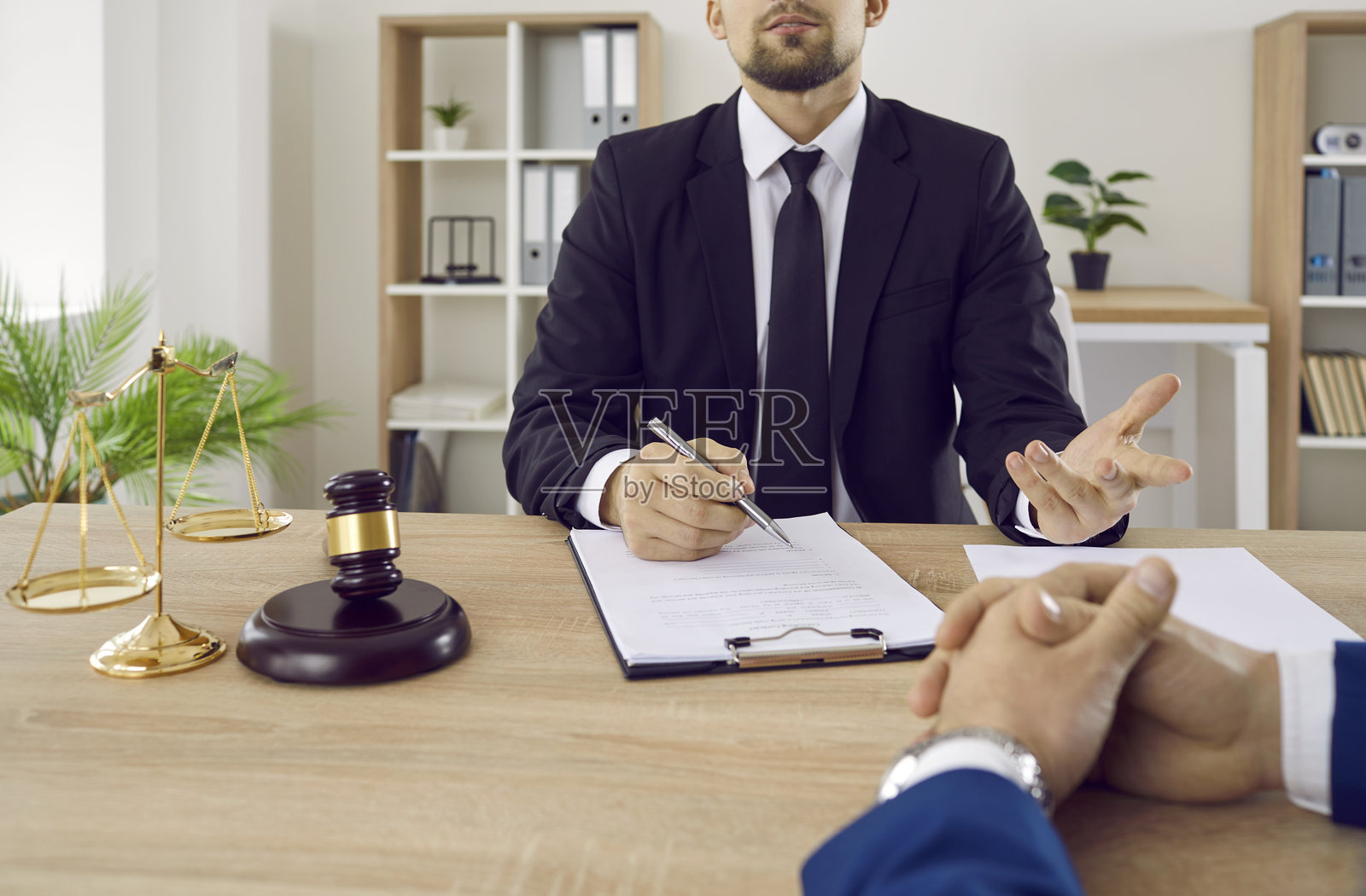 律师、公证人或法官在办公室与商务客户咨询并讨论合同文件。照片摄影图片