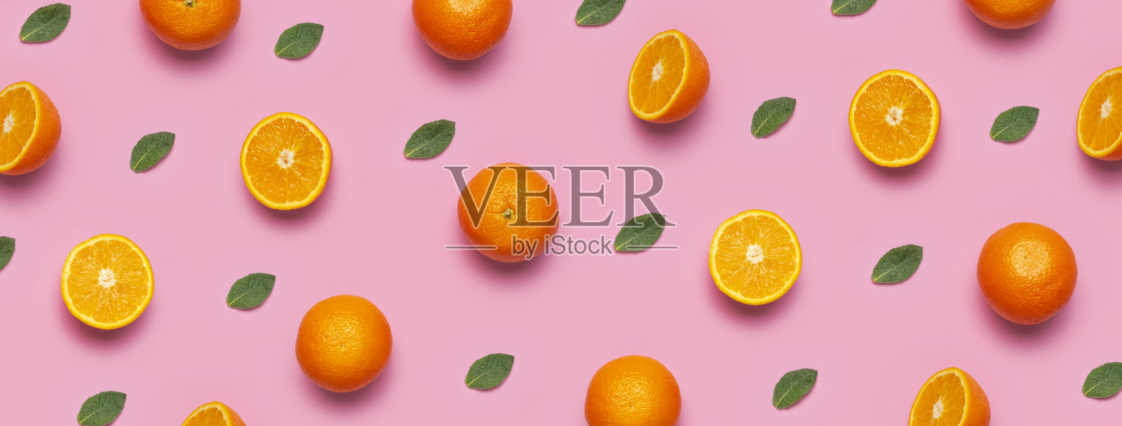 水果图案,创意夏日概念。新鲜多汁的完整和切片橙子,薄荷叶在粉色背景上。俯视平面图。柑橘类水果的极简主义背景,维生素C。波普艺术设计照片摄影图片