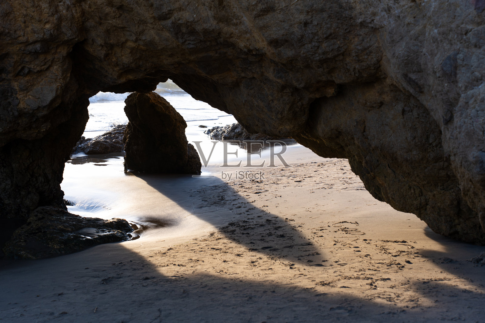 日落时分,崎岖的海岸拱门映衬着太平洋照片摄影图片