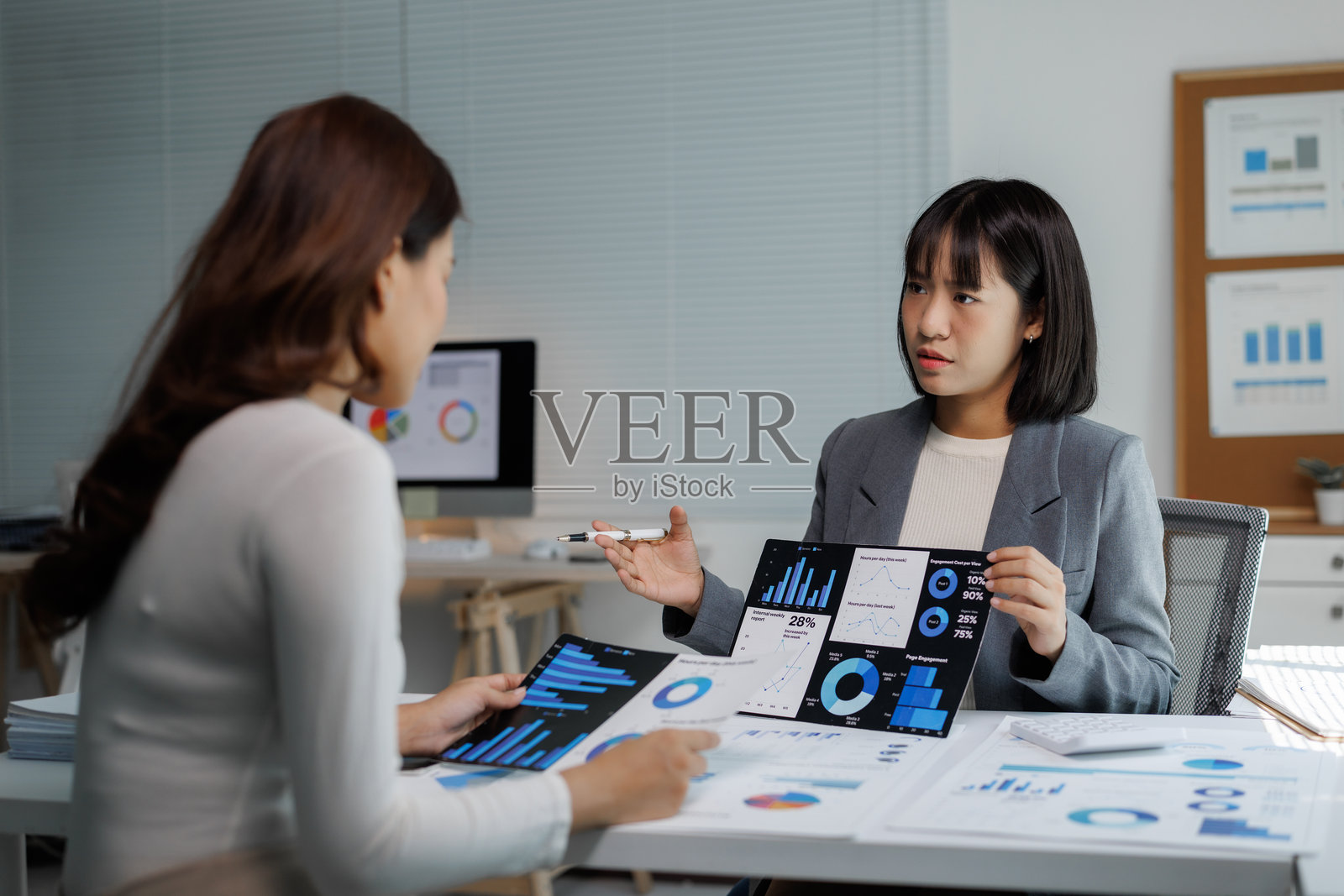 女商人们在分析财务数据并展示市场报告照片摄影图片