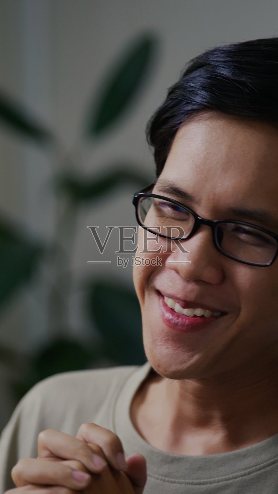 放松的亚洲男性在家中感到满足和情绪良好。照片摄影图片