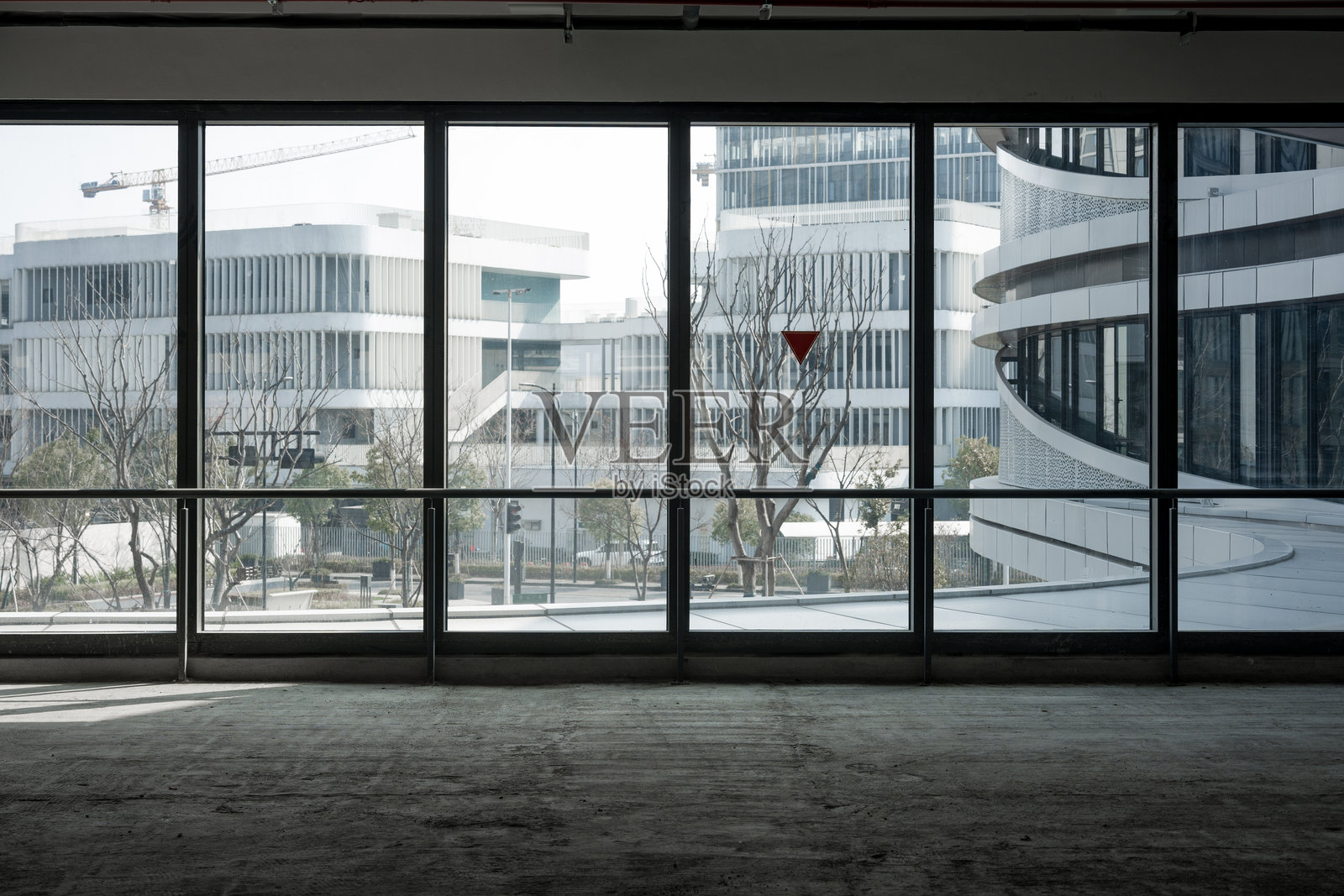 空旷室内透过落地窗望现代建筑群照片摄影图片