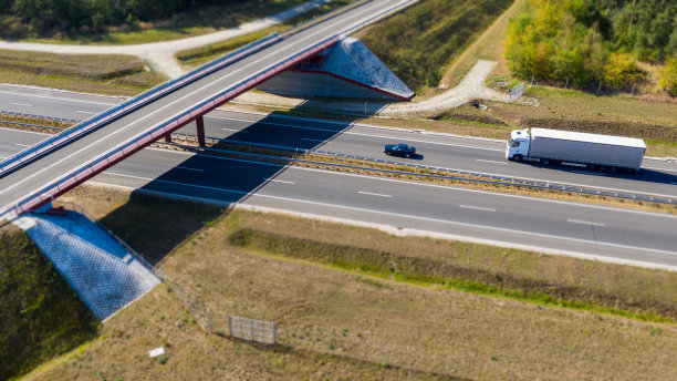从上面看,在桥下的公路上行驶的卡车。图片 从上面看,在桥下的公路上行驶的卡车。图片下载
