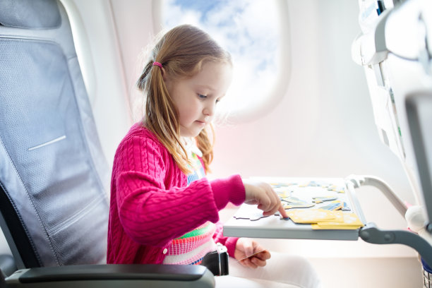 孩子在飞机。飞与家人。孩子们旅行。图片 孩子在飞机。飞与家人。孩子们旅行。图片下载