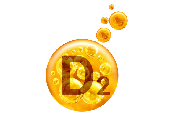 维生素D2胶囊。白色背景上带有孤立气泡的金色小球。健康的生活方式的概念。图片 维生素D2胶囊。白色背景上带有孤立气泡的金色小球。健康的生活方式的概念。图片下载