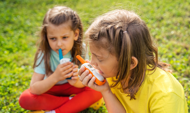 小孩子,女孩玩对讲机。带频道的对讲机。侦探和间谍的游戏。孩子们在远处交谈,传递信息。在森林、公园、徒步旅行中与家长交流。寻找迷路的人图片 小孩子,女孩玩对讲机。带频道的对讲机。侦探和间谍的游戏。孩子们在远处交谈,传递信息。在森林、公园、徒步旅行中与家长交流。寻找迷路的人图片下载