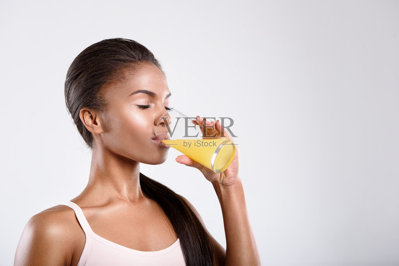 平静健康的女人正在喝果汁正版图片素材