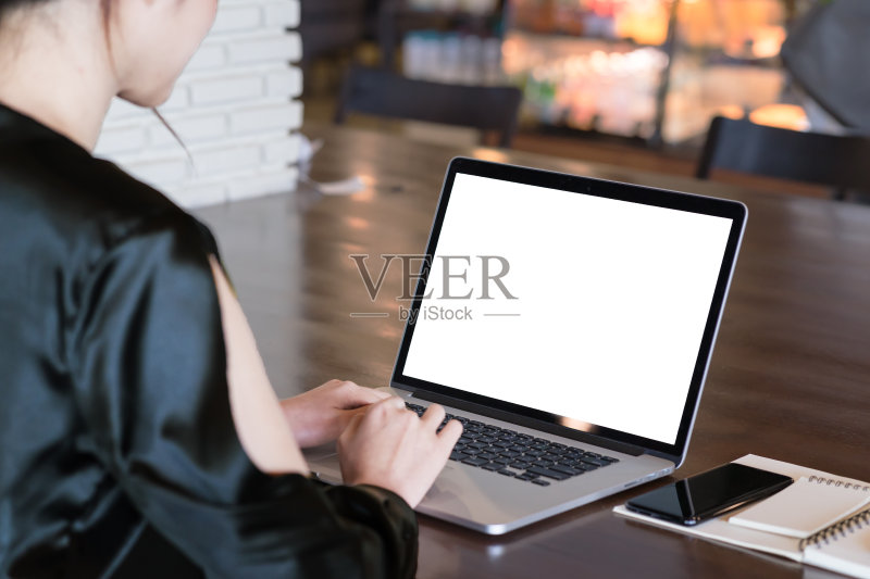 后视图亚洲女性自由职业者在笔记本电脑上工作与空白拷贝空间在屏幕上为您的广告图片或文本信息。正版图片素材