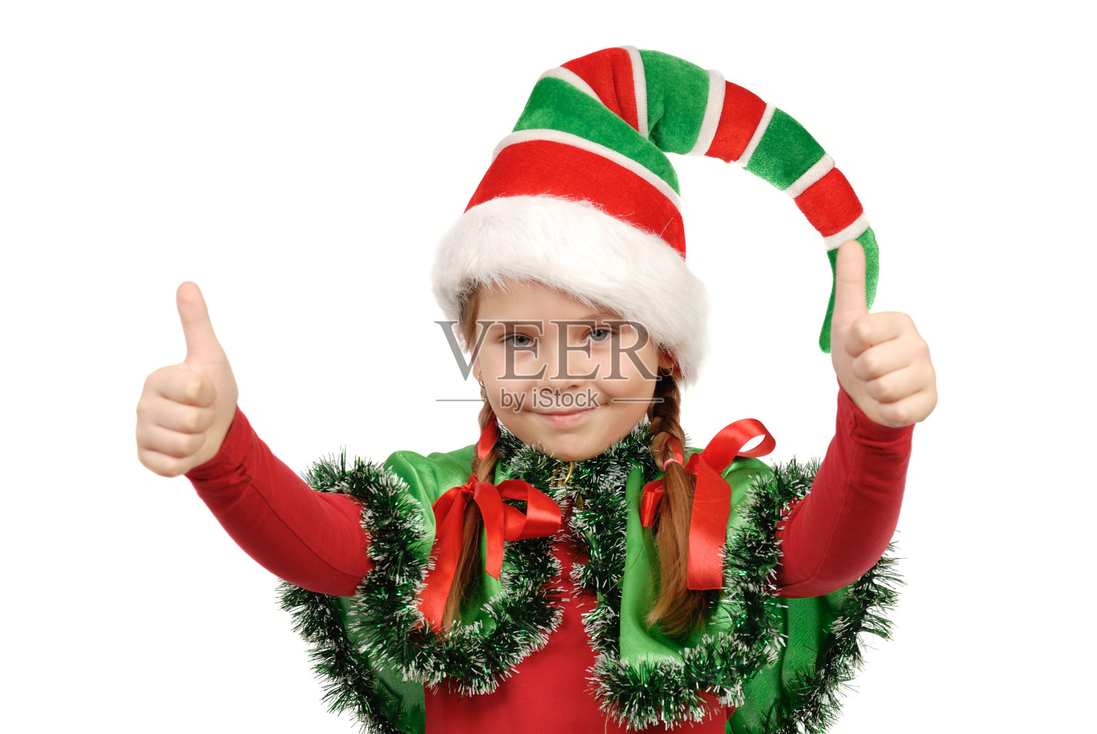 穿着精灵圣诞老人套装的女孩。照片摄影图片