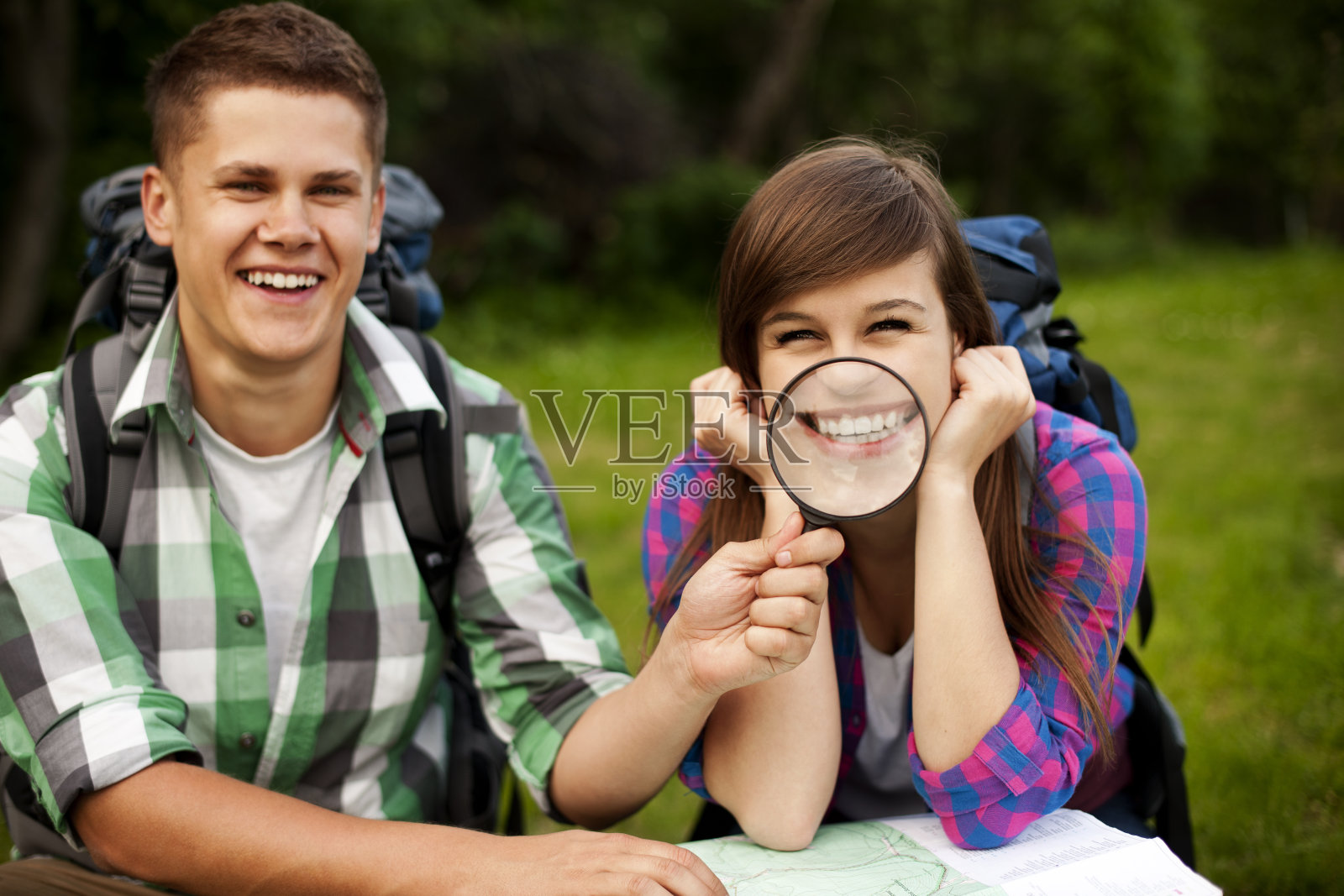 年轻夫妇带着地图在森林里照片摄影图片