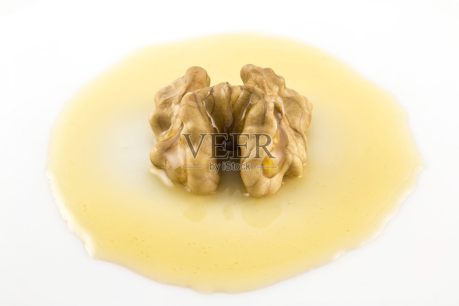 胡桃木上的蜂蜜照片摄影图片