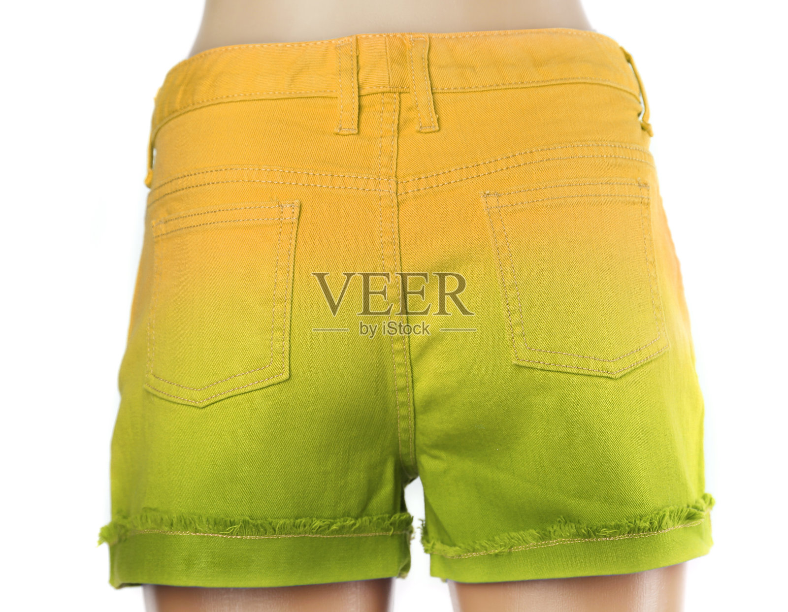 黄色的绿色女性牛仔裤短裤。照片摄影图片