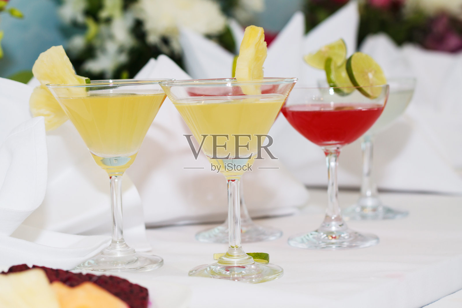 桌上有异国情调的鸡尾酒和鲜花照片摄影图片