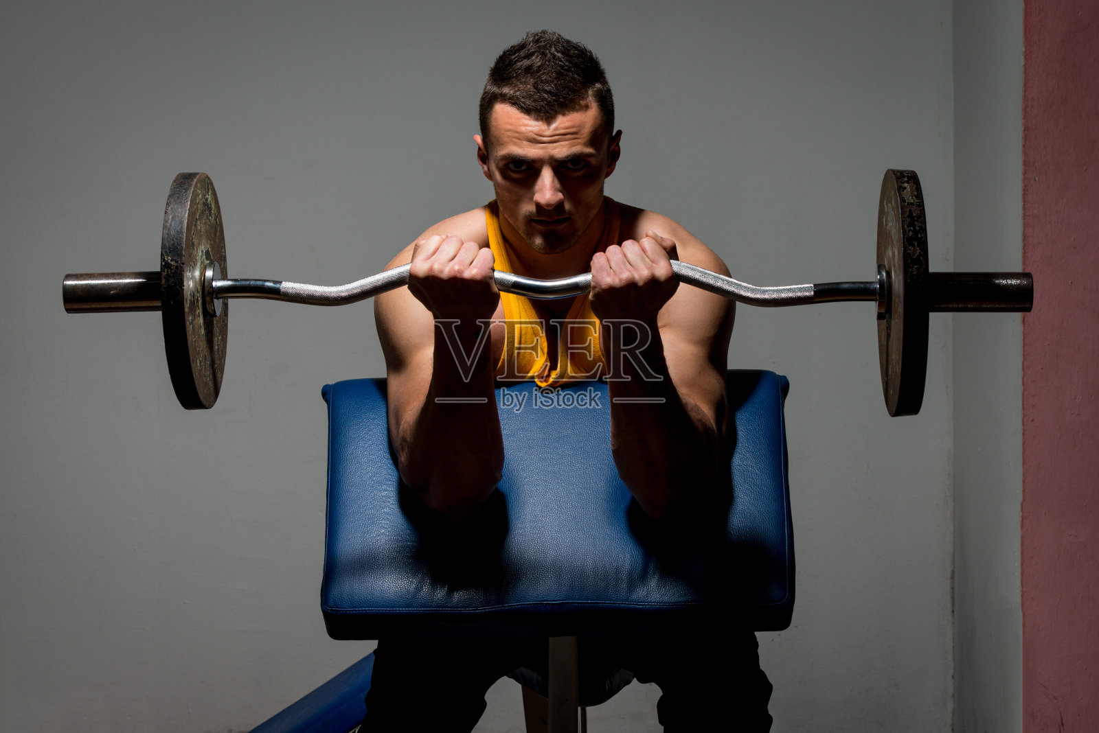健身教练正在为肱二头肌做举重锻炼照片摄影图片