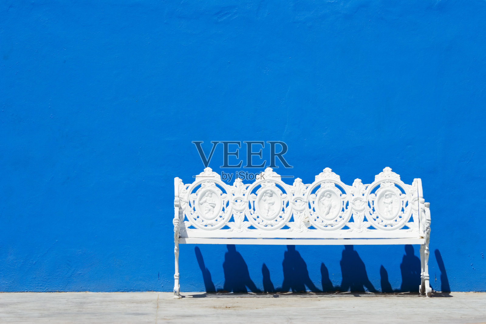 蓝墙，白长凳照片摄影图片