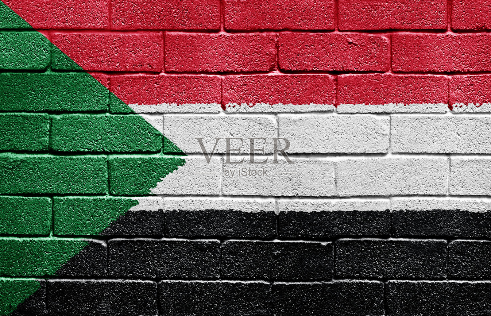 砖墙上的苏丹国旗照片摄影图片
